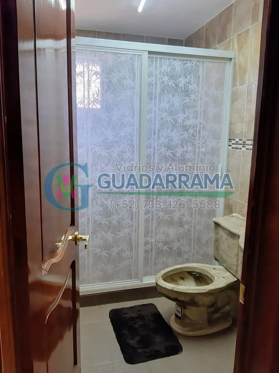 Cancel corrediza para baño en aluminio blanco, con panel plástico y película decorativa de bambú que aporta privacidad sin quitar luz.