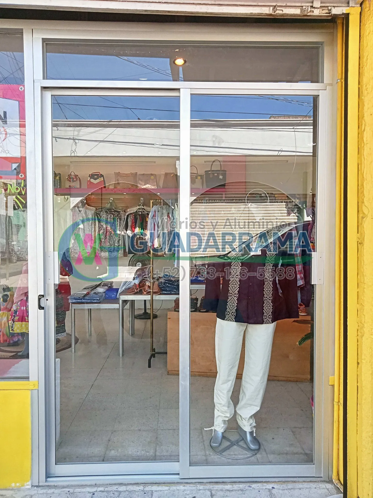Este cancel corredizo de aluminio natural para exterior lleva vidrio transparente con película de seguridad, ofreciendo una vista limpia sin sacrificar la protección de tu espacio.